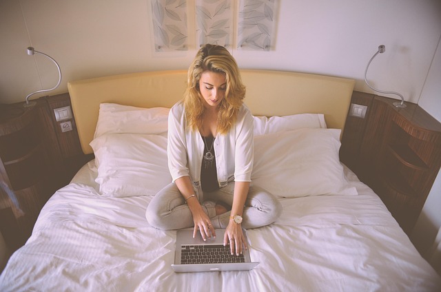 person typing a prompt into an AI chat interface on a laptop with blue and purple UI accents